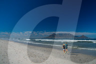 Joggers running on Blouberg Beach in the early morning, with Table Mountain in the background, Cape Town, South Africa