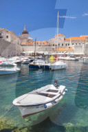 Fishing boat and clear water in the Old Port, Dubrovnik Old Town, Dalmatian Coast, Dubrovnik, Croatia, EU, Europe