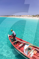 Fisherman with his catch of fish in a traditional fishing boat, Santa Maria, Sal island, Cape Verde, Africa
