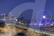 View of Star Ferry pier, observation wheel and Tsim Sha Tsui skyline, Central, Hong Kong, China