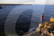 A woman hiking at St Govan's Head on the Pembrokeshire Coast, Wales