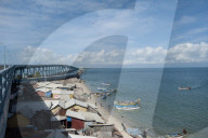 Fisherman community under Pamban Bridge with colourful fishing boats, Pamban Straits, Rameshwaram, Tamil Nadu