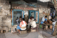 Barbers cutting hair and shaving men, and tobacco wallah, in streetstalls outside Xerox shop in Dalhousie Square area of Kolkata