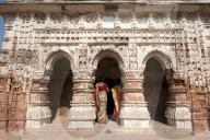 Two women in saris visiting the Lalji terracotta Hindu temple, built in 1739 and dedicated to Radha Krishna, Kalna,West Bengal