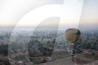 Hot air balloon in the early morning, flying over countryside and the village of Samode, Rajasthan