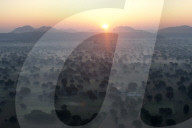 Sun rising over the hills and countryside surrounding Samode, from hot air balloon, Rajasthan