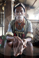 Gangchung Wangben, Naga man, headhunter, wearing horn earrings, Naga necklaces with brass heads and elephant tusk arm bands,
