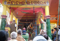 Shaman in highly altered state of consciousness performing problem solving ritual for villagers gathered in Hindu temple, Odisha
