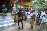 Shaman in altered state of consciousness with Shamanic drummer and cymbal, performing problem solving ritual in Hindu temple