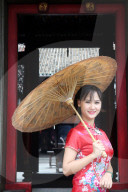 Taoist temple. Phuoc An Hoi Quan Pagoda. Woman wearing Vietnam traditional dress called Ao Dai.