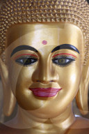Close-up of a pink-lipped Buddha statue. Cambodia.