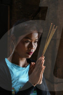 Khmer woman praying in a temple. Cambodia.