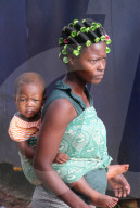African baby carried on the back of his mother. Togo.