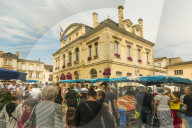 Stalls & the Mairie in town hall square on market day in this old bastide town. Sainte-Foy-la-Grande; Gironde; Aquitaine; France