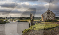 A view of boats moored in the creek at Thornham, Norfolk, England.