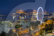 Elevated view of Malaga Marina and ferris wheel at dusk, Malaga, Costa Del Sol, Andalusia, Spain, Europe