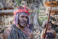 Village chief and community of the Abui Tribe dressed in traditional clothing, Alor Island, Indonesia.
