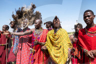 Masai Mara members sing tribal songs to greet guests to their village, Masai Mara National Reserve, Kenya.
