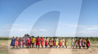 Masai Mara members sing tribal songs to greet guests to their village, Masai Mara National Reserve, Kenya.