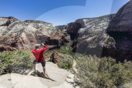 Photographer shooting the valley floor from Angel's Landing Trail in Zion National Park, Utah, USA.