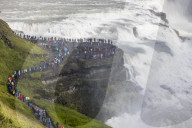 Tourists visiting iconic Gullfoss, Golden Falls, Olfusa River in southwest Iceland.