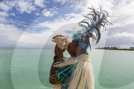 A conch shell blowing warrior welcoming guests to Aitutaki, Cook Islands.