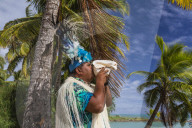A conch shell blowing warrior welcoming guests to Aitutaki, Cook Islands.