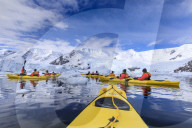 Kayaking amongst spectacular icebergs, mountains and glaciers, sunny Neko Harbour, Anvord Bay, Antarctic Peninsula, Antarctica