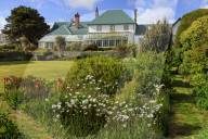 Government House, 1845, conservatory, green iron roof, beautiful grounds, blue sky, sun, Stanley, Port Stanley, Falkland Islands