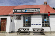 Stop sign and Globe Tavern British Pub, picnic tables, Stanley, Port Stanley, Falkland Islands