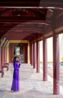 Vietnamese woman in traditional Ao Dai dress and Non La conical hat in the Forbidden Purple City of Hue