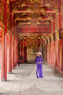 Vietnamese woman in traditional Ao Dai dress and Non La conical hat in the Forbidden Purple City of Hue