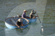 Cham island fishermen in traditional coracle round basket fishing boats