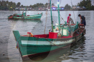 Fishing boat at the morning fish market on the banks of the Preaek Tuek Chhu River in Kampot town