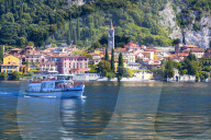 People on boat trip around the village of Varenna, Lake Como, Lecco province, Lombardy, Italy
