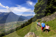Family with children walk on footpath to Alpe Bassetta, Lower Valtellina, Sondrio province, Lombardy, Italy