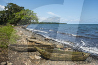 Wooden canoes on the rocky coast of Bioko, Equatorial Guinea