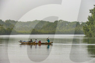 Locals in a canoe on a river east of Buchanan, Liberia
