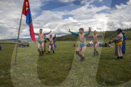 The wrestlers display their strong physique in a warm up 'Eagle Dance' whilst their coaches announce their heroic deeds.