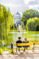 Couple sitting on a bench in Saxon Garden, Warsaw, Poland, Europe