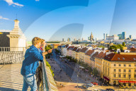 Couple looking at Palace of Culture and Science and skyscrapers, City Centre, Warsaw, Poland, Europe