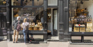Tourists looking at display of food shop in Amsterdam, Netherlands, Europe