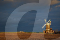 Storm clouds move in over the reedbeds towards Cley Windmill at Cley Next the Sea, Norfolk, England, United Kingdom, Europe
