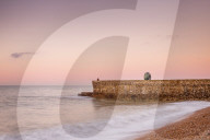 Fisherman and the Green Doughnut sculpture at dawn on Brighton Seafront, Brighton, East Sussex, England, United Kingdom, Europe