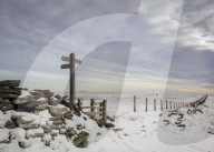 Looking across snow covered fields in the Peak District to the Cat & Fiddle Inn in the White Peak.