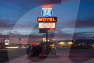 Historic Route 66 neon sign glowing at sunset