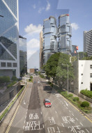 Red taxi cab in Central, Hong Kong Island, with the Bank of China Tower and Lippo Centre beyond, Hong Kong