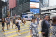 People crossing a busy road in Central, Hong Kong Island's busy shopping and business district, Hong Kong