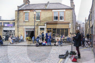 Busker entertains in Columbia Road area, a very popular Sunday market between Hoxton and Bethnal Green in East London.