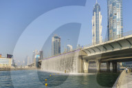 Dubai Water Canal Waterfall Bridge, the waterfall parts to allow boats to pass under. Business Bay, Dubai, United Arab Emirates